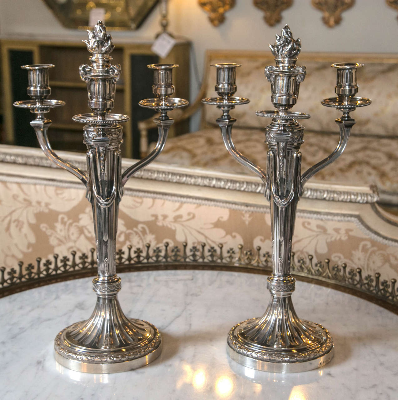 Pair of Andre Aucoc French Continental candelabras, 1887-1911. Each Stamped on Base with Maker's Mark - Finely detailed and solid pair that will add shimmering warmth and beauty to all of your dining or evening events. 

Andre Aucoc known for