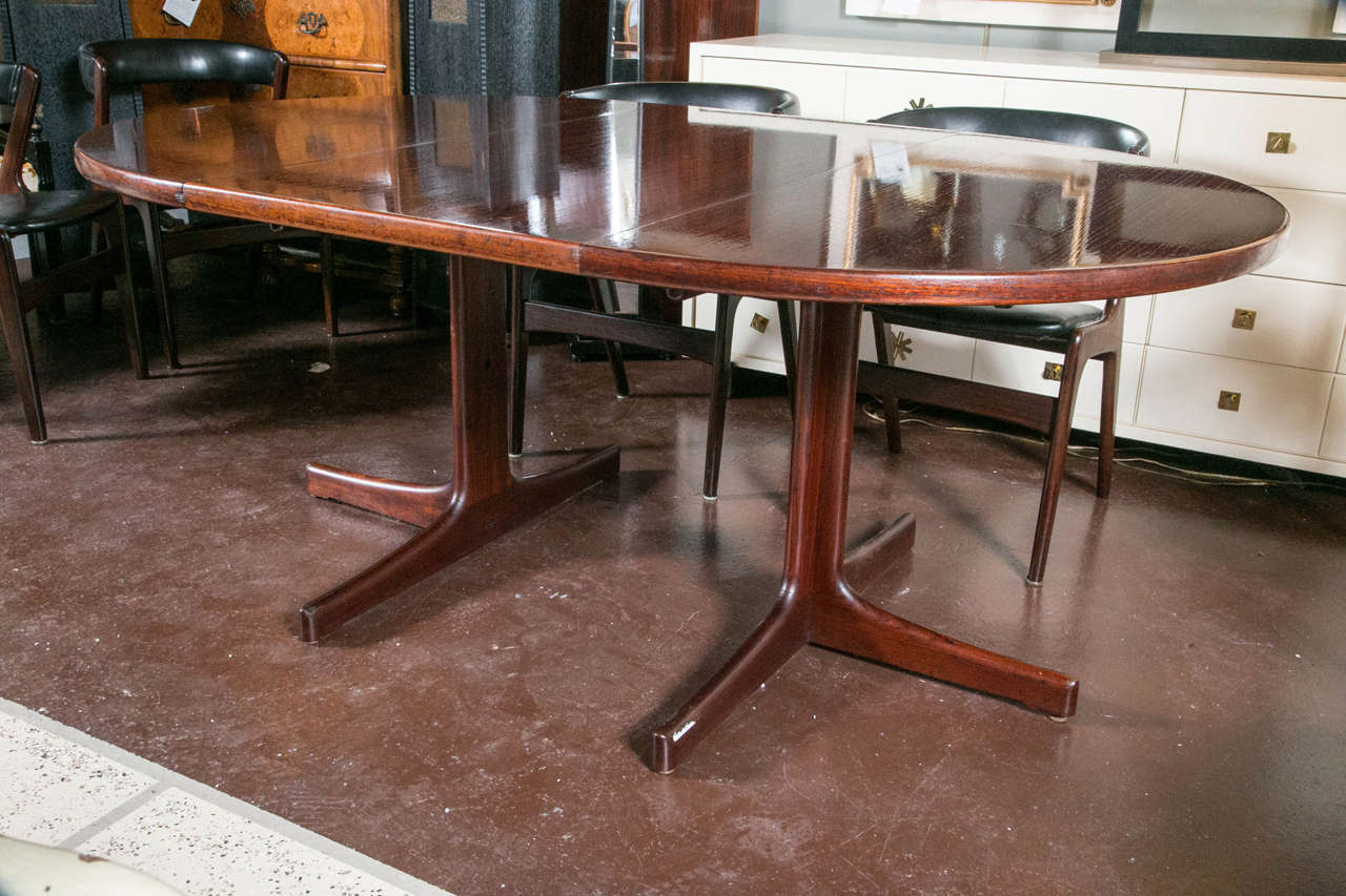 Mid-Century dining table Denmark circular. Beautiful rosewood designed with a modern streamlined base. Two 23.5