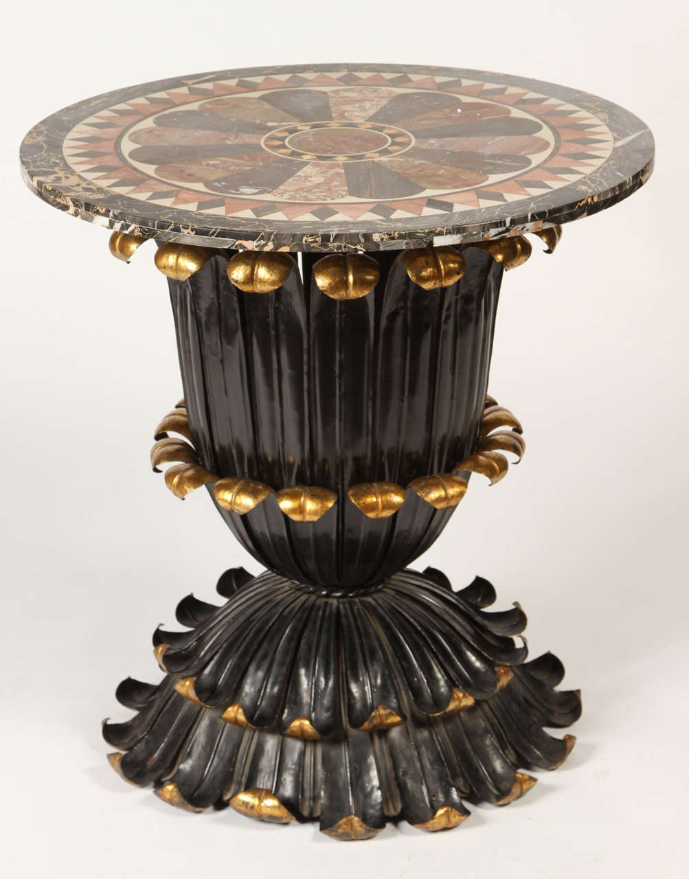 This stunning table from the late 19th century has a fantastic marble specimen top and a painted and gilt foliage-inspired base. The deep color palette contrasts wonderfully with the feminine organic silhouette. This table would be perfect for a