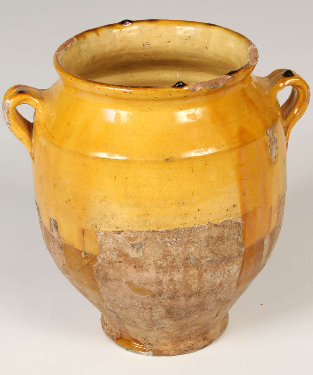 19th Century confit pot with colourful glaze in ochre on the top half and unglazed on the bottom. Earthy weathered patina. Nice as a decorative piece for use indoors or in a garden or on a terrace. Large enough for use as a planter for a small