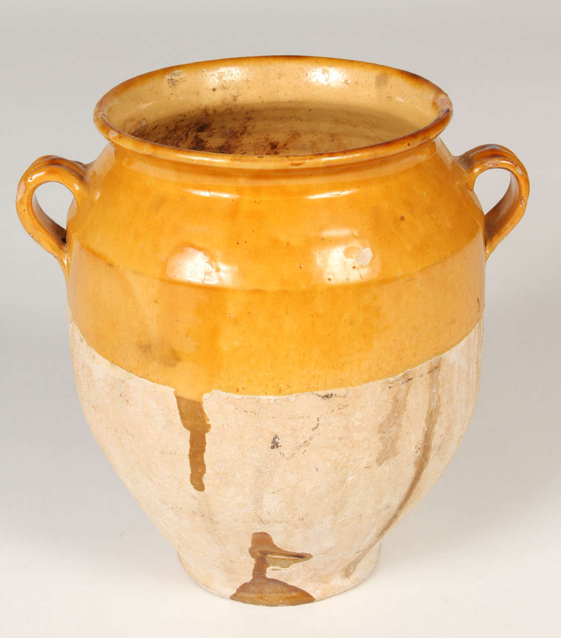 19th Century confit pot with colourful glaze in ochre on the top half and unglazed on the bottom. Earthy weathered patina. Nice as a decorative piece for use indoors or in a garden or on a terrace. Large enough for use as a planter for a small