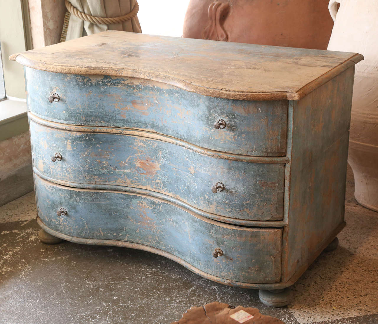 18th century serpentine commode in pine. Original blue paint and hardware. Beautiful shape, scale and patina.
