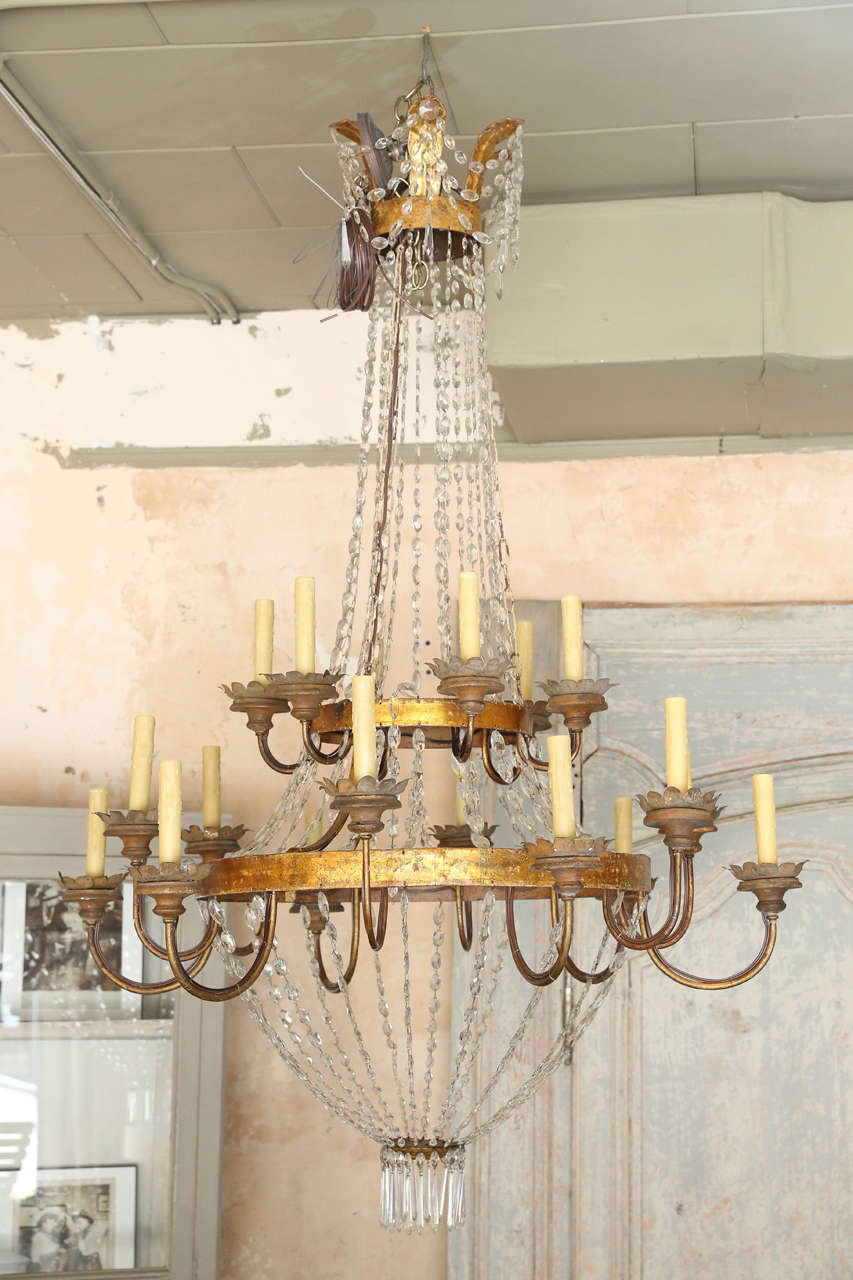 Beautiful gilded iron, tole and crystal chandelier from Lucca, Italy. Newly-wired with eighteen lights, chain and a canopy.