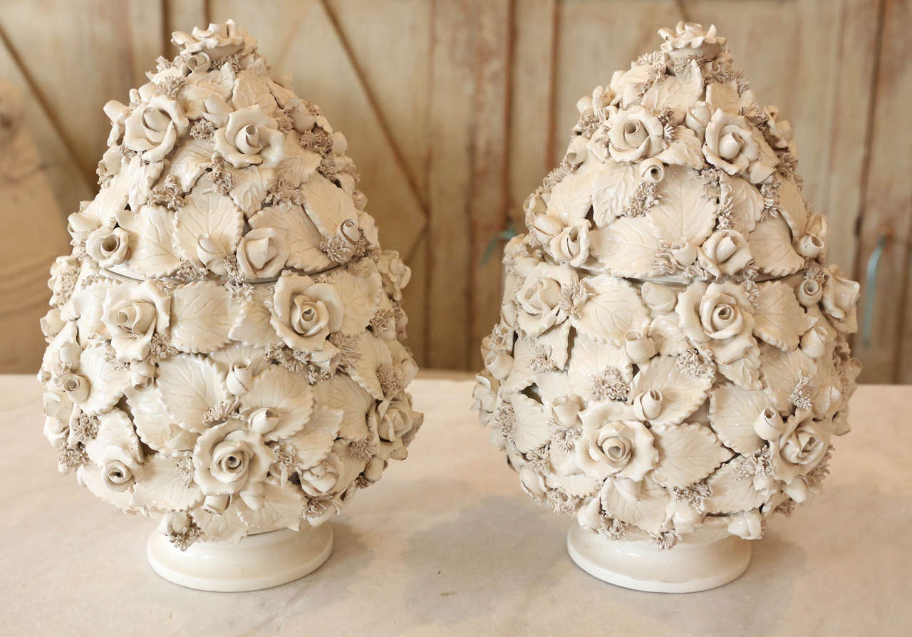 Pair of creamware topiaries. Beautifully detailed with flowers and leaves. One small chip to one jar, see image 9.