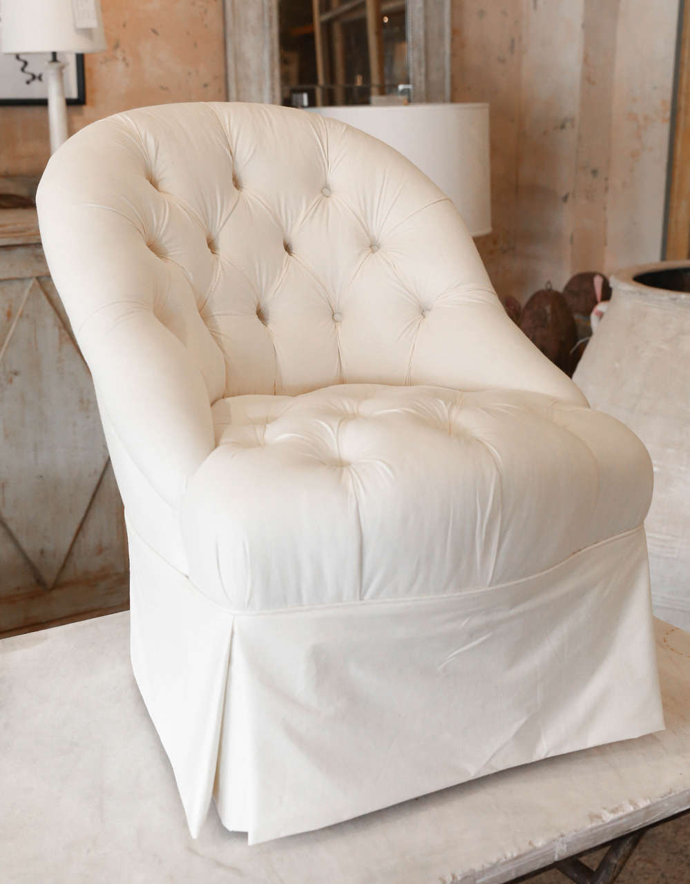 Newly upholstered slipper chair, tufted,and in ticking.