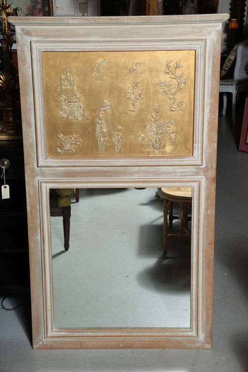 Elegant white washed frame with an oriental embossed copper design above the mirror plate.