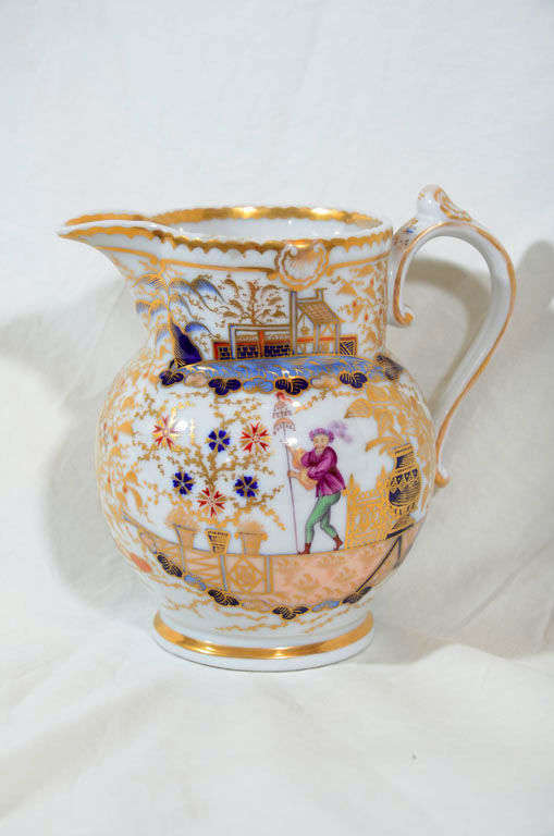 An early 19th century Chamberlain Worcester elaborately gilded jug with a single acrobat on each side. Started in 1788 Chamberlain's Worcester was one of the finest English porcelain factories. For an image of this pattern (See Geoffrey Godden