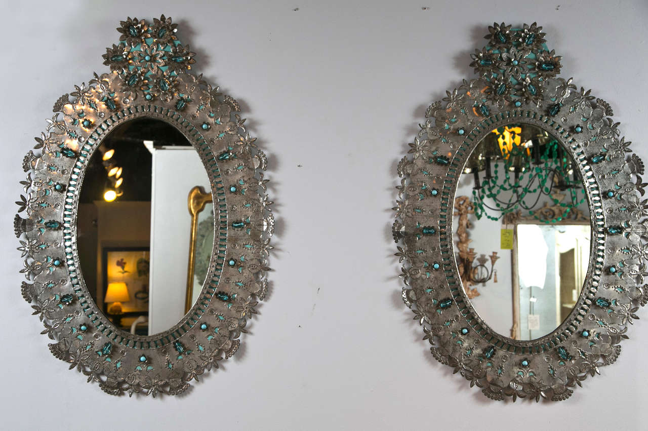 Pair of Mexican tin oval mirrors, c.1950s. 1