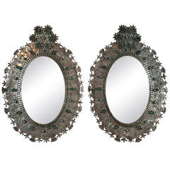 Pair of Mexican tin oval mirrors, c.1950s.