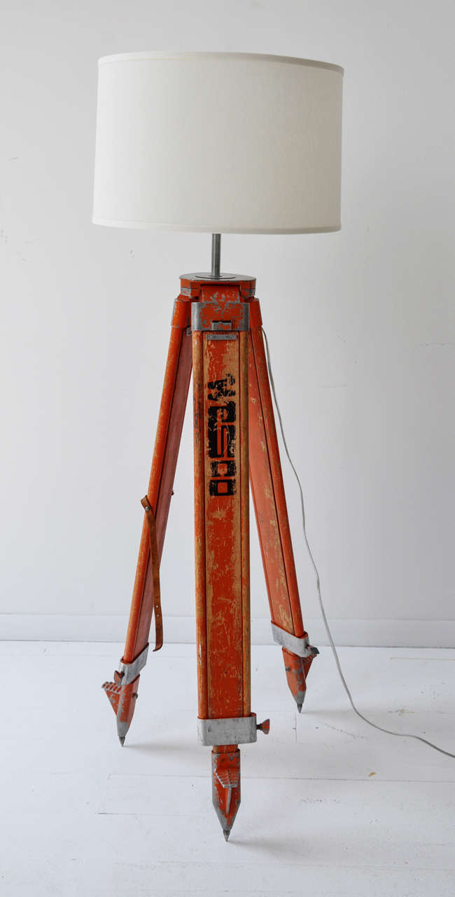 Orange surveyor's lamp with distressed finish, silver hardware, and a new drum shade and finial. The orange color is a very rare find!