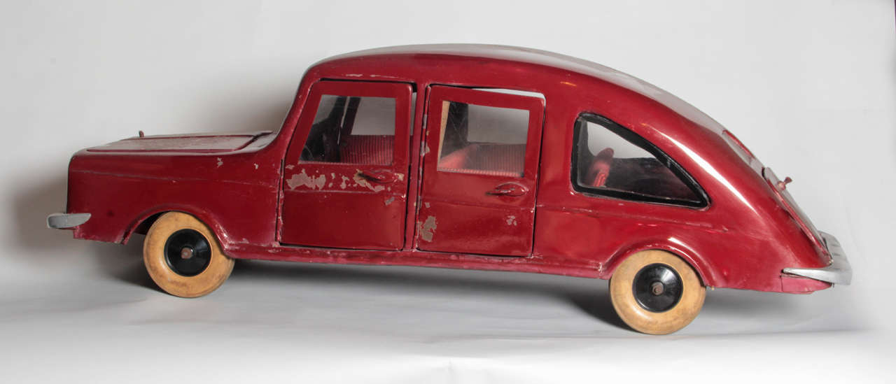 This homemade fantasy car is in remarkable condition for a 1940s maker’s model. Complete with upholstered interior, rolling wheels, latching doors and trunks, it would be a wonderful addition to a car lover’s collection.
