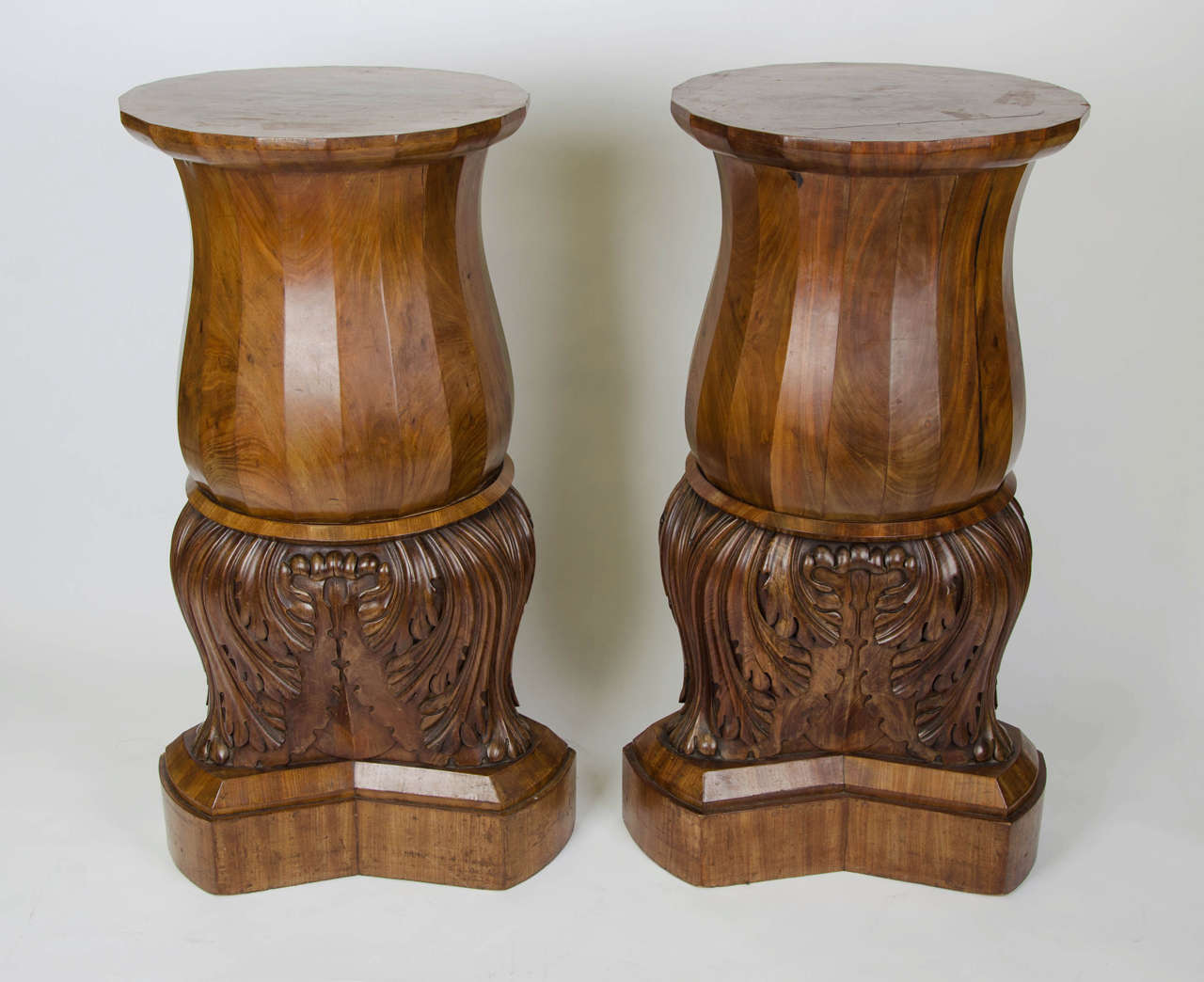 Strong pair of North European mahogany pedestals having acanthus carved bases and facetted tops. c 1835