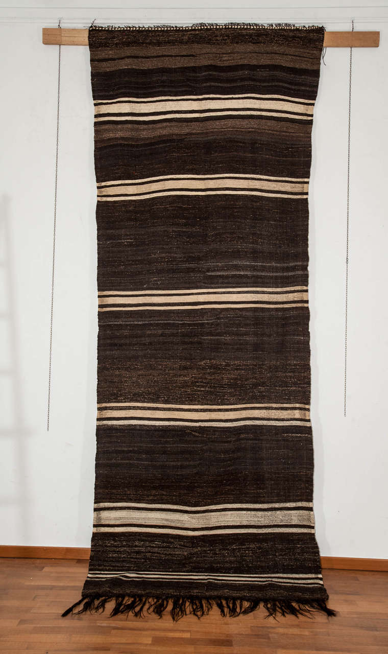 A rare Turkish flat-weave from the Toros Mountains near Karapinar distinguished by the use of goat hair for the dark brown-black background as well as for the warps. This results in a particularly sturdy fabric with an almost black/white palette.
