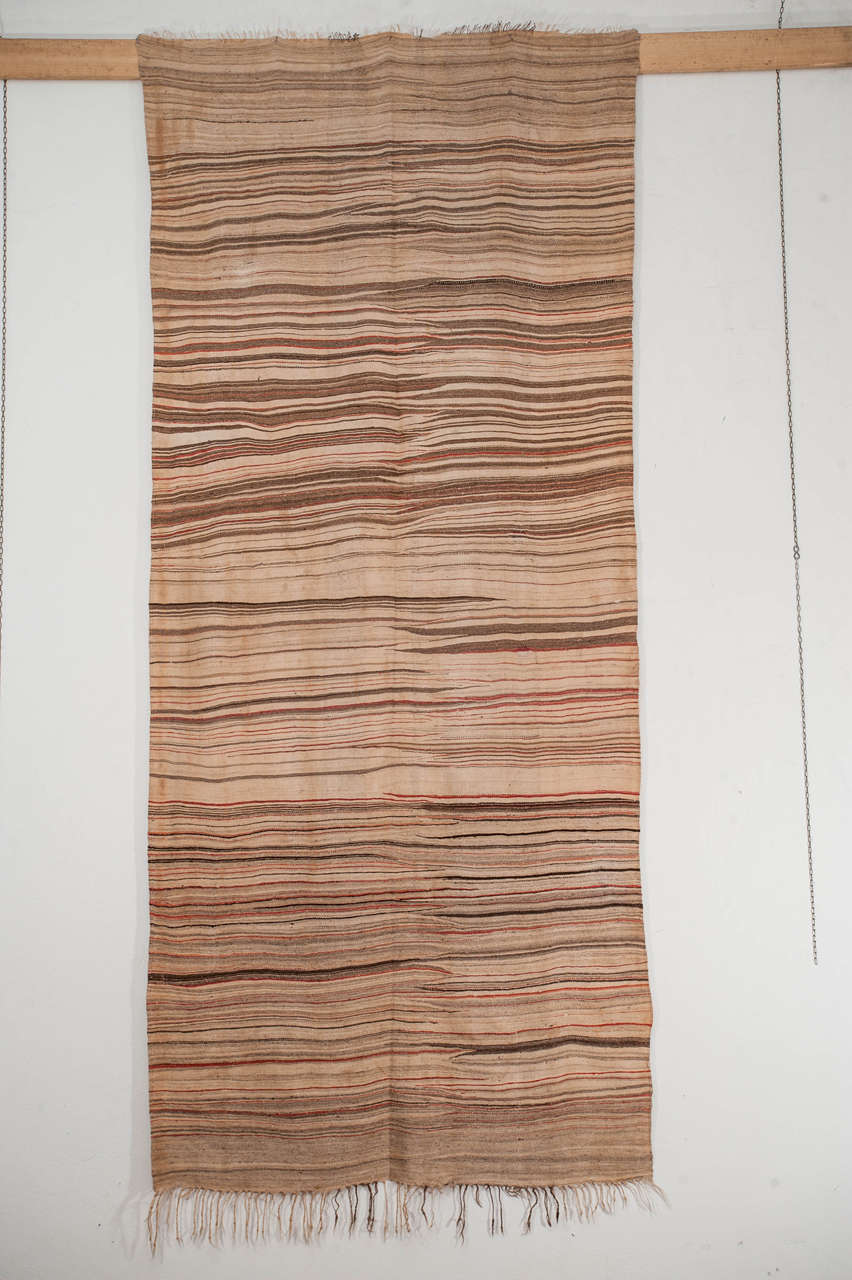 A finely woven haik from the Mejjat tribe, located in the most southern part of the Moroccan Anti Atlas region. Distinguished for their blanket-like handle and for their unique iconography, where the weft directed patterns converge towards the