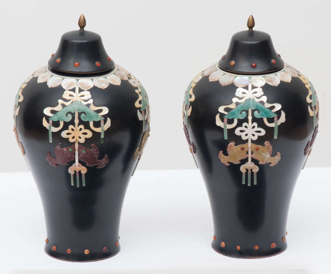 A pair of Chinese Meiping form vases with lacquer over bronze inlayed with carved stone and mother of pearl, circa 1900.