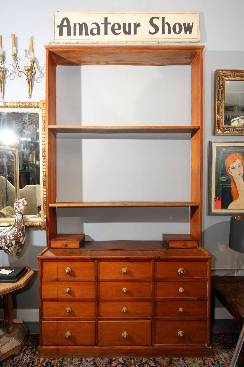 Fourteen-drawer cabinet with pull-out shelf, most likely cheery wood.
Four shelves included.