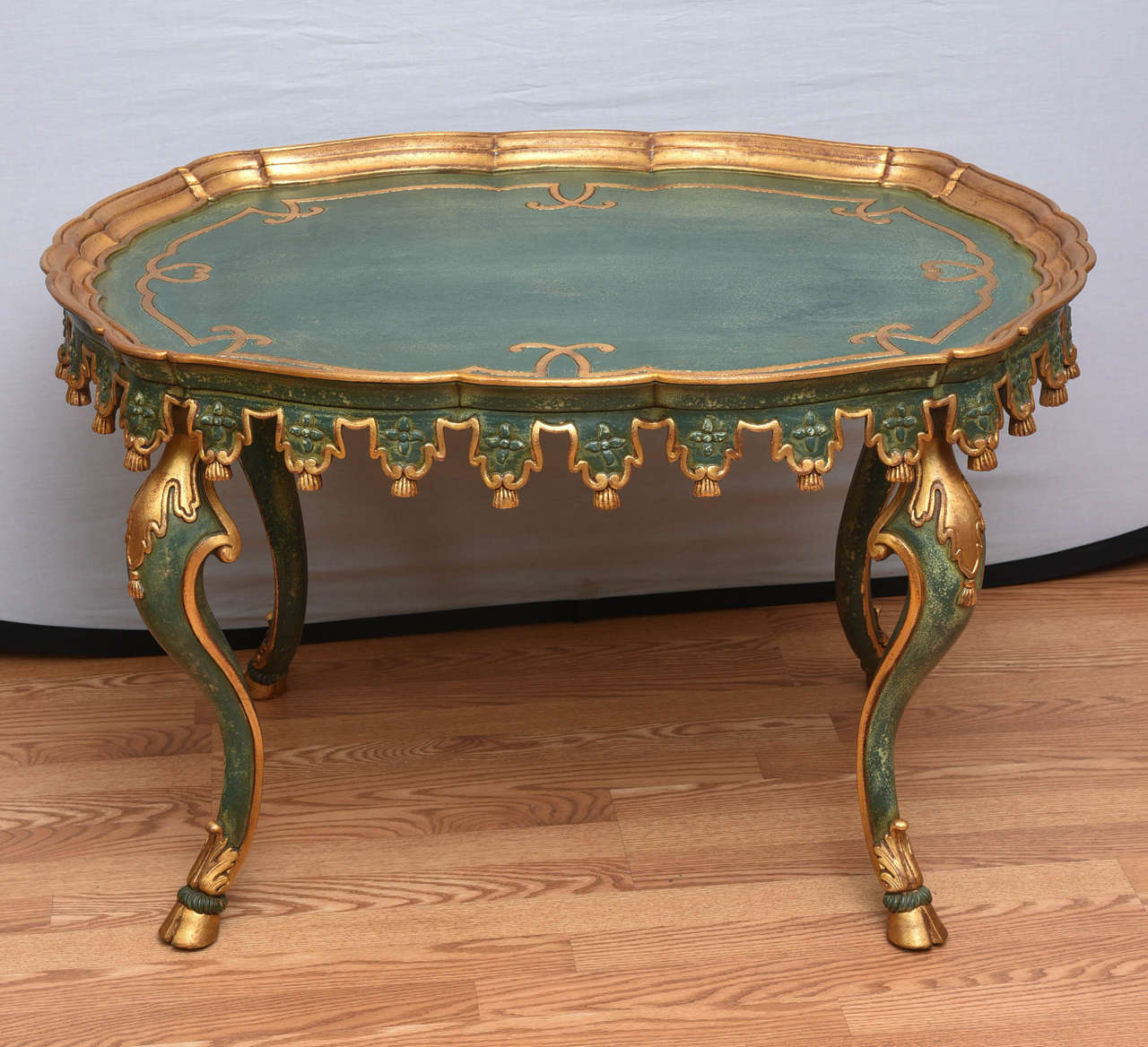 Interesting teal and gold carved wood tea height table.