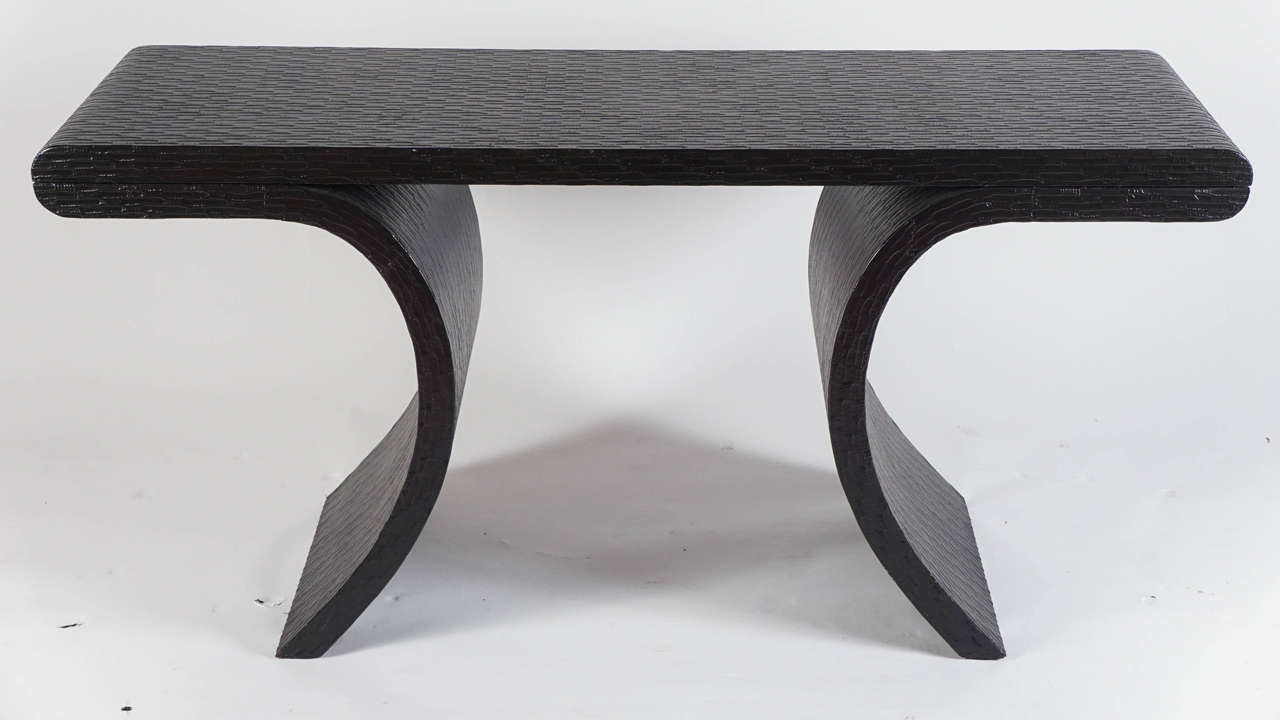 An unusual bow-legged shape and textured black veneer material make this striking piece.  Mint vintage condition.