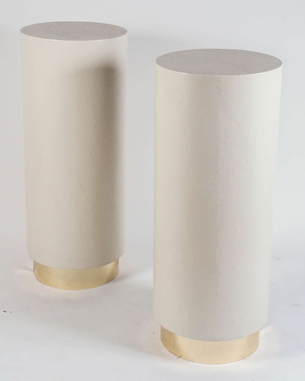 Chic and simple:  lacquer wrapped columns on brass plinth bases.   Great vintage condition.