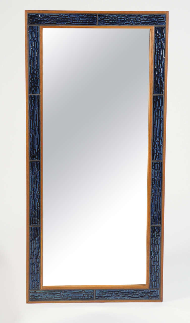 Textured ceramic tiles and teak-colored wood frame.  Mirror and frame in mint vintage condition.
