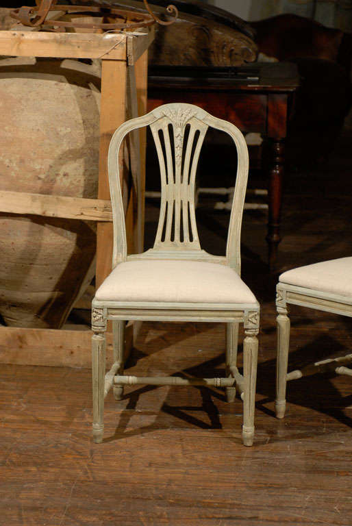 A set of four painted Swedish late Gustavian Style wheat back painted wood side chairs, mid-20th century, upholstered seat.