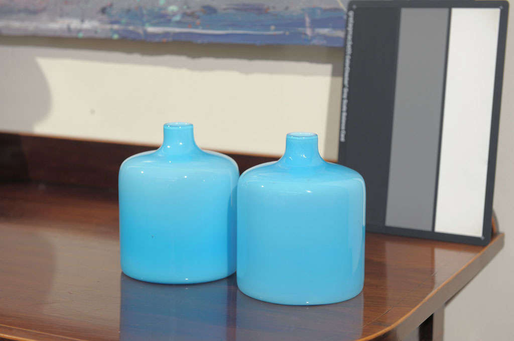 Fantastically mod, these cool aqua blue vases are perfect to perch on a shelf, table or vanity. Priced and sold indivdually.