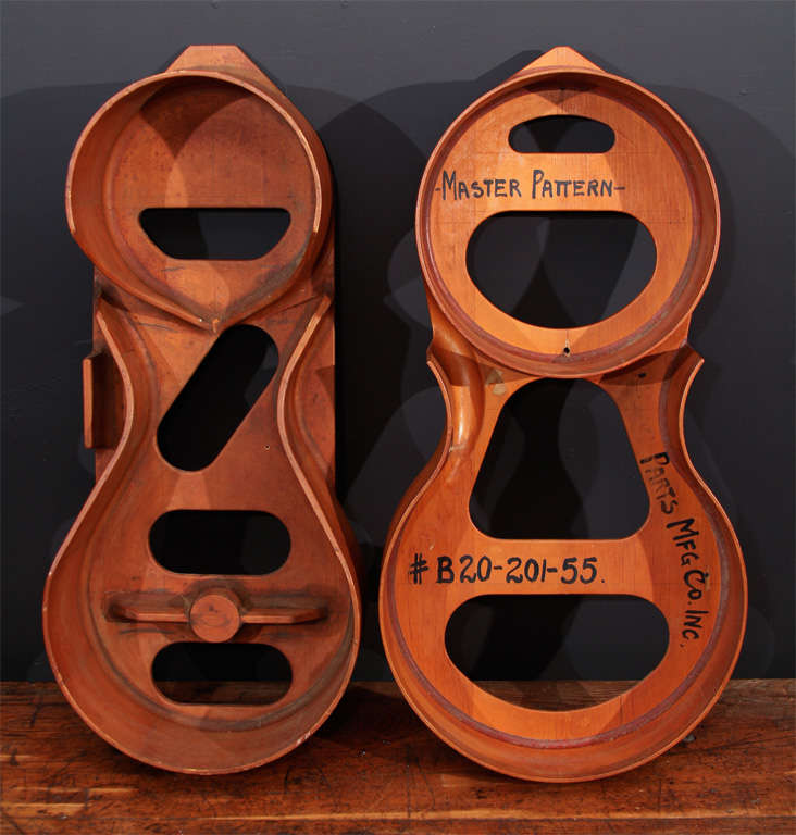 Beautifully curved steam-bent plywood guitar molds made by the Union Parts Mfg Co. Inc.;  these are signed Master Pattern Model #20-201-55.  Sculptural and geometric with such warm colors.