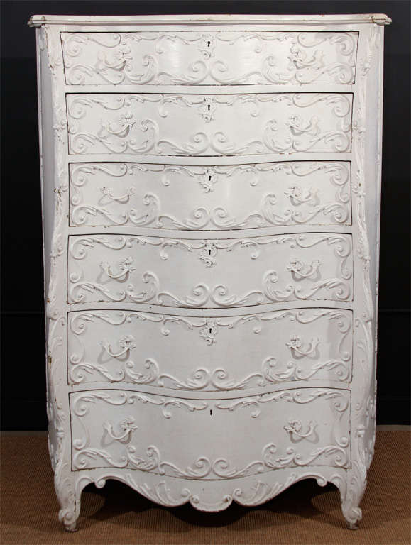 Over-the-top and highly sculptural, this white-painted chest of drawers in the Rococo style is spectacular.  Made in New York in 1903 and overpainted in many shades of white over the years, this piece slopes and curves in the most beautiful and