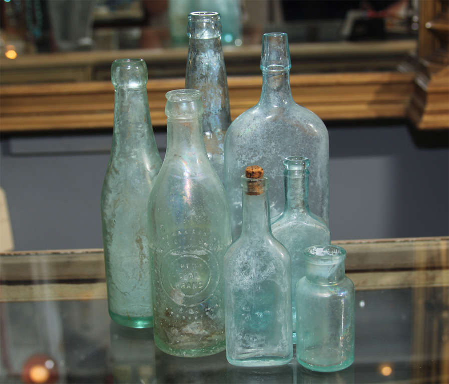 Nice collection of old aqua bottles in varying sizes and condition. Very pretty in kitchen, bathroom or bedroom.