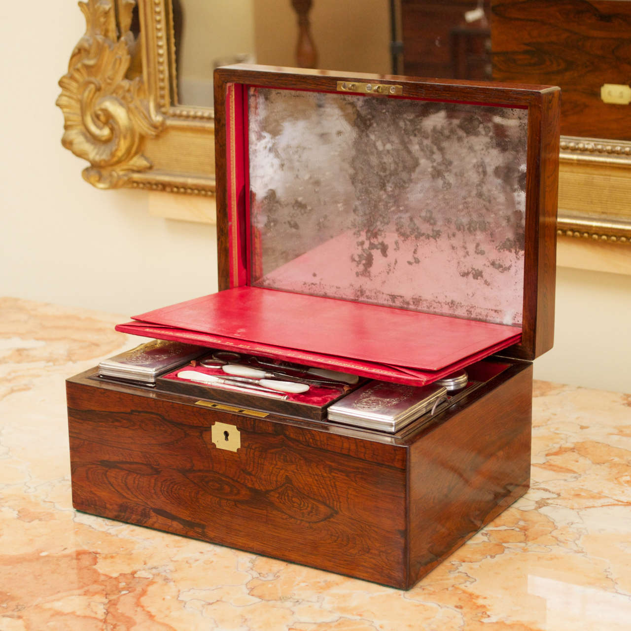 A gorgeous Victorian mahogany dressing box by Edwards with fitted interior. Hidden under the velvet cover is a removable easel mirror and leather stationery compartment embossed with 