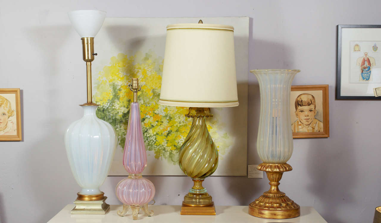 Set of four vintage table lamps, by A. Seguso based on the island of Murano Italy. Lamps may also be purchased separately. From left to right:
1st: Large Opaline glass sitting on a wooded pedestal base, one light socket with cone milk glass shade.