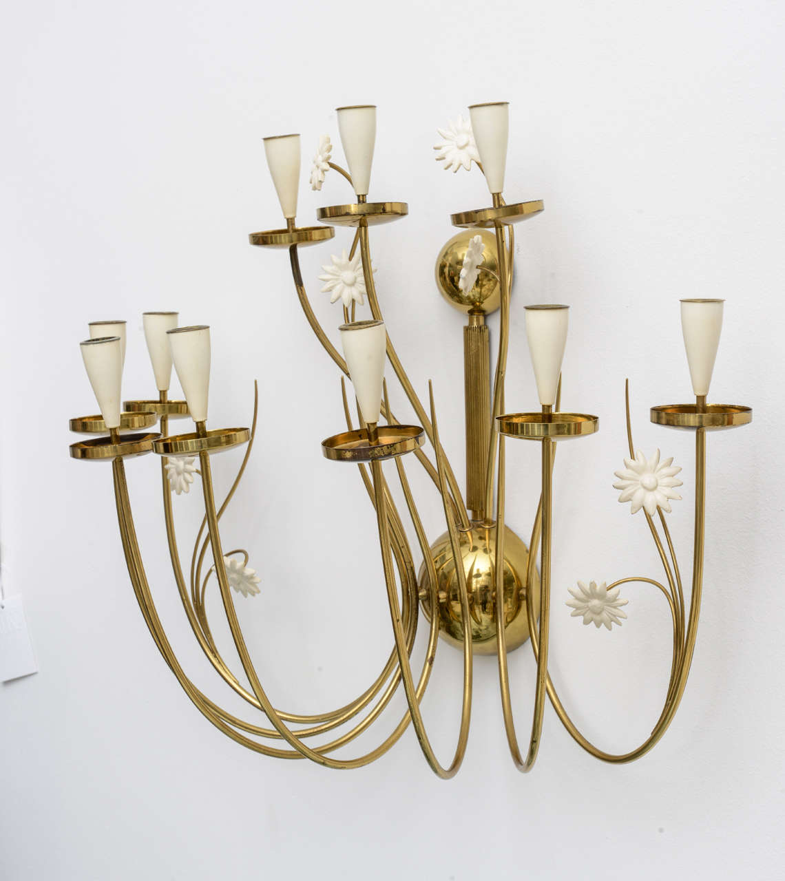 Our over-sized 50's Italian candle sconce delights the eye with delicately curving brass arms and whimsical white painted flowers... and did we mention its impressive scale? So charming with all 10 candles lit over a small sideboard or soaking tub!