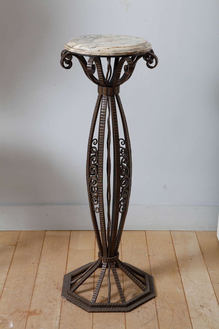 This elegant circular wrought iron pedestal is decorated with stylised foliage motif and has a marble top.

H. 127 0 cm, Dia. 41 cm.