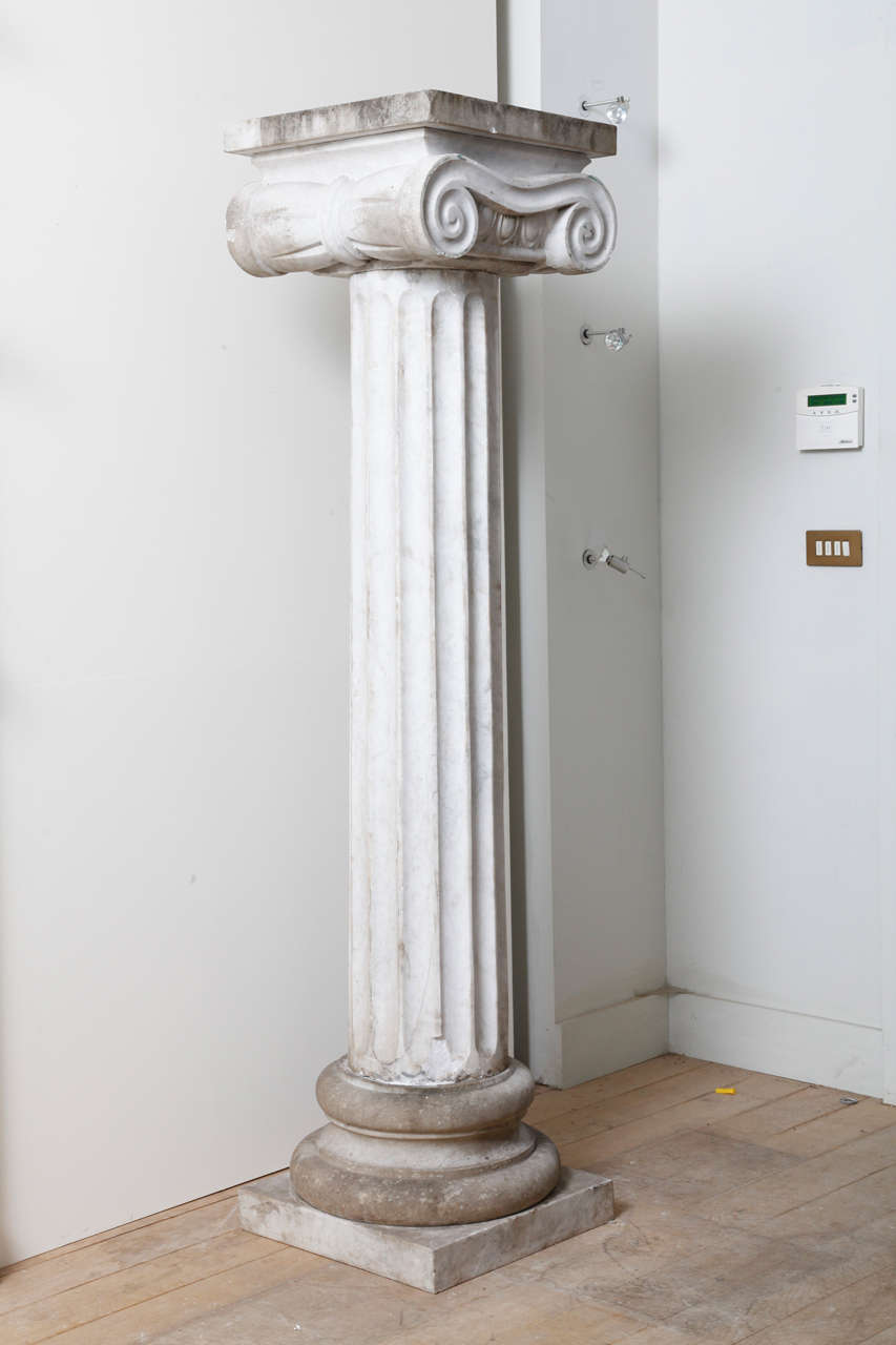 The major features of the Ionic order are the volutes of its capital. Above the volutes an abacus, below a fluted shaft, a base and a stylobate; no krepis in this case.

H. 200 cm, base W. 49 cm, L. 49 cm.