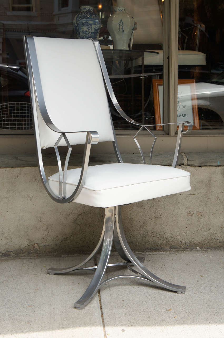 Two Mid-Century Chrome and Vinyl swivel Chairs.