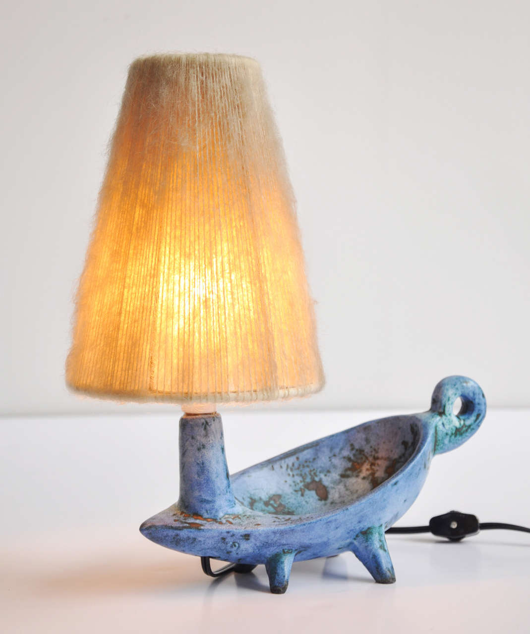 An enchanting, small footed table lamp by the French ceramic artist Jacques Blin.  Captivating fabric shade is original to the piece.  It is rare to find Blin lamps with their original shade. Signed on base.