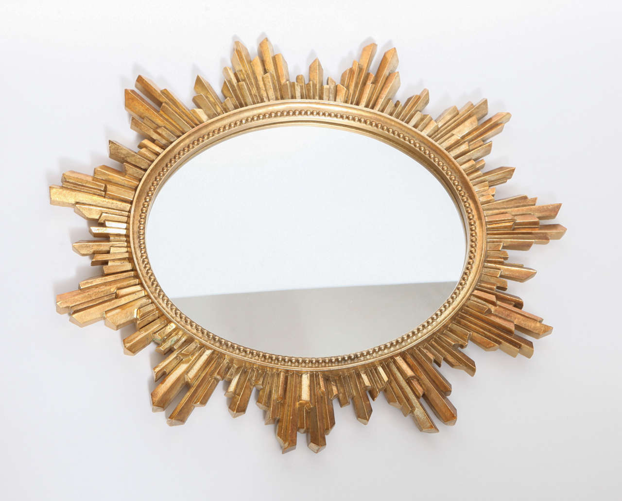 A bright classic sunburst mirror with gold halo with new mirror