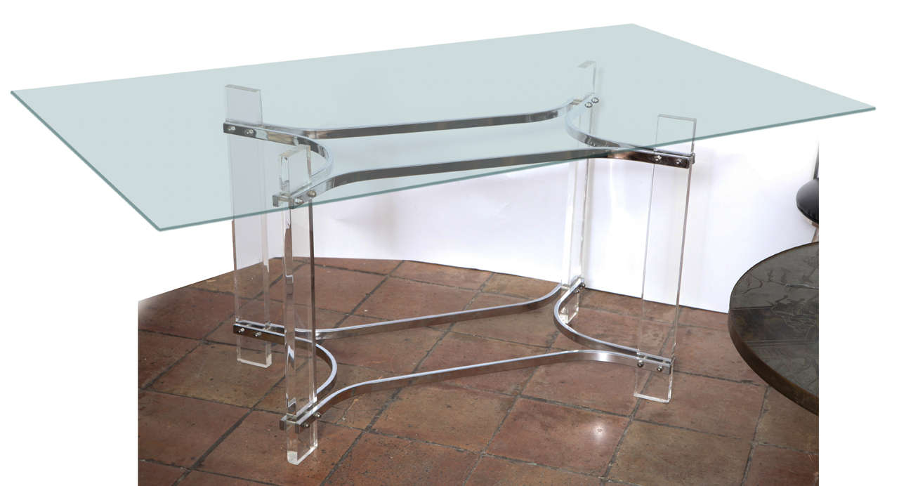A great modernist table by the furniture designer Charles Hollis Jones with lucite and chrome plated metal supports and glass top with polished edges.