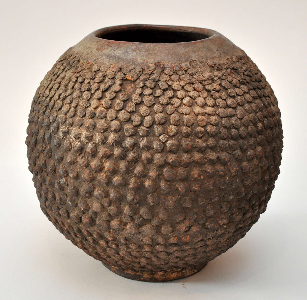 Vessel created by the Lobi People of Burking Faso, Mali Africa<br />
Terracotta warted vessel.