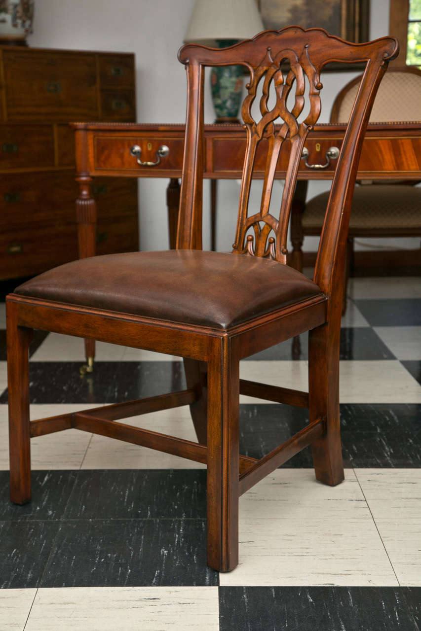 Classic George III style carving defines these dining chairs. Lyrically executed, the lines traverse the back while providing comfortable support in a chair that on first inspection looks as though it may have placed form over function. Add the
