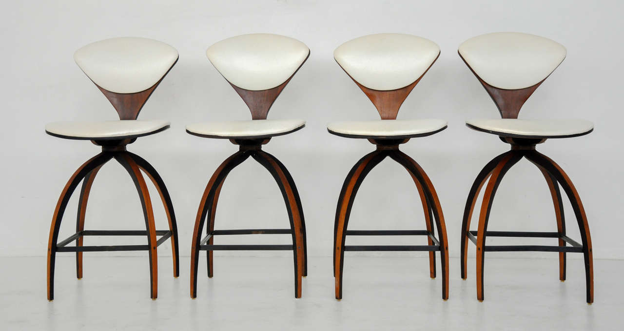 Sculptural form counter stools designed by Norman Cherner for Plycraft. Original white vinyl seat pads.