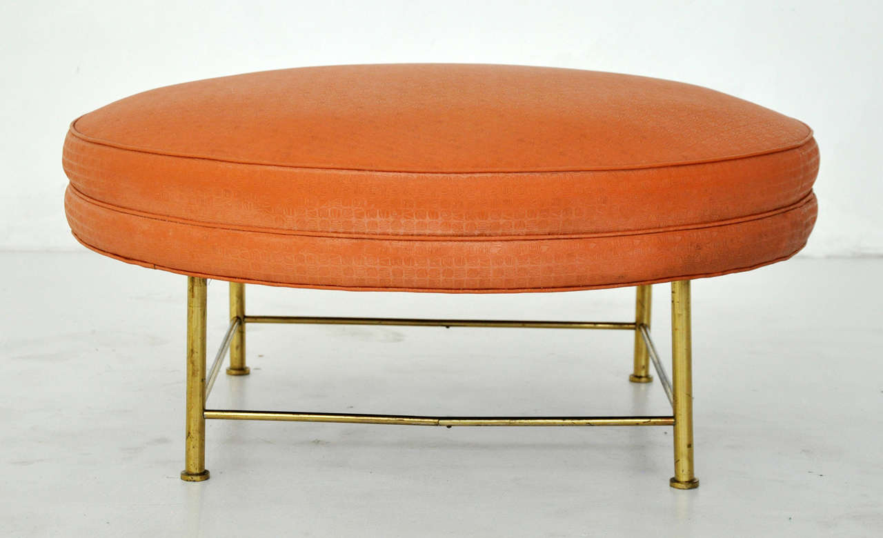 Round ottoman with brass frame. Designed by Harvey Probber.