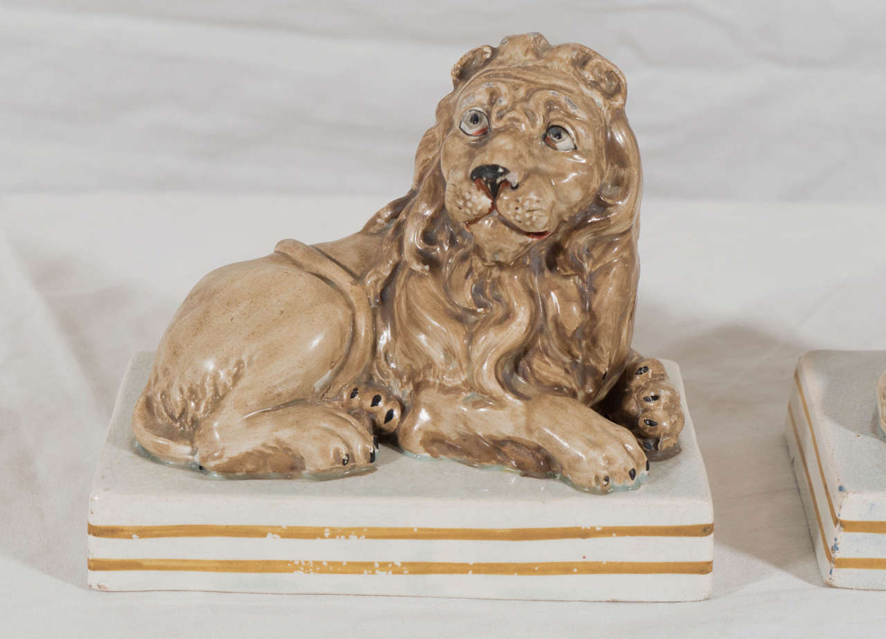 These exceptional pottery lions were made by Wood and Caldwell who produced some of the best English ceramics at the beginning of the 19th century. The modeling of the lions captures the regal sentiment of the 