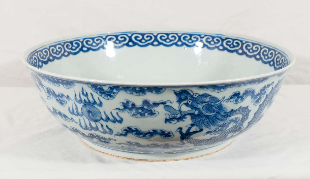 An 18th century, Qianlong Blue and White bowl well-painted in tones of cobalt blue, the exterior with two flying dragons amidst scattered cloud wisps. In Chinese tradition the dragon is a symbol of power, strength, and good luck for people who are