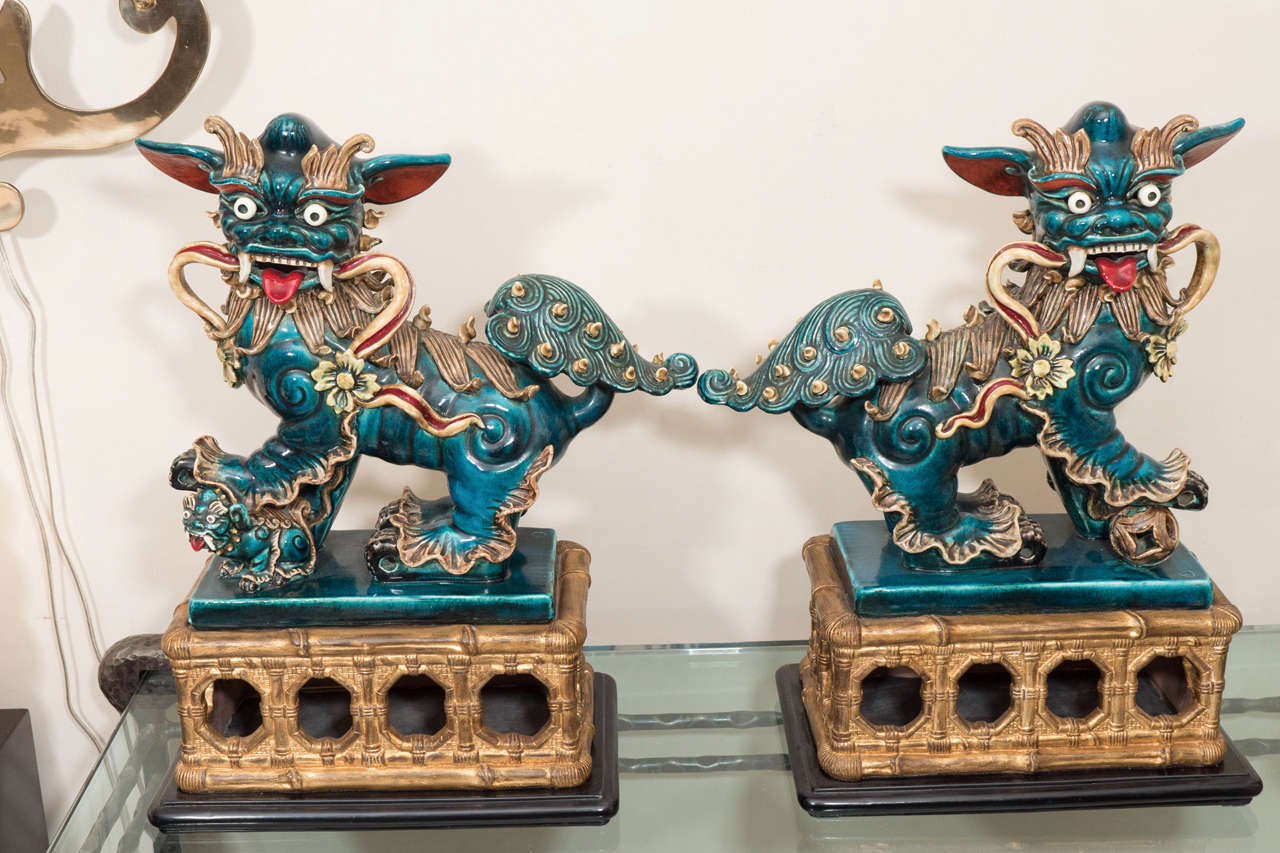Pair of chinoiserie majolica dragon sculptures.
