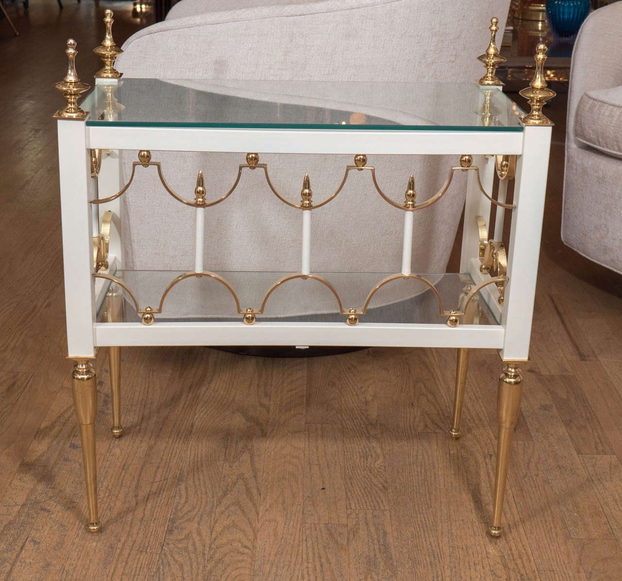 Pair of rectangular brass, white enameled metal and glass side tables with decorative details.