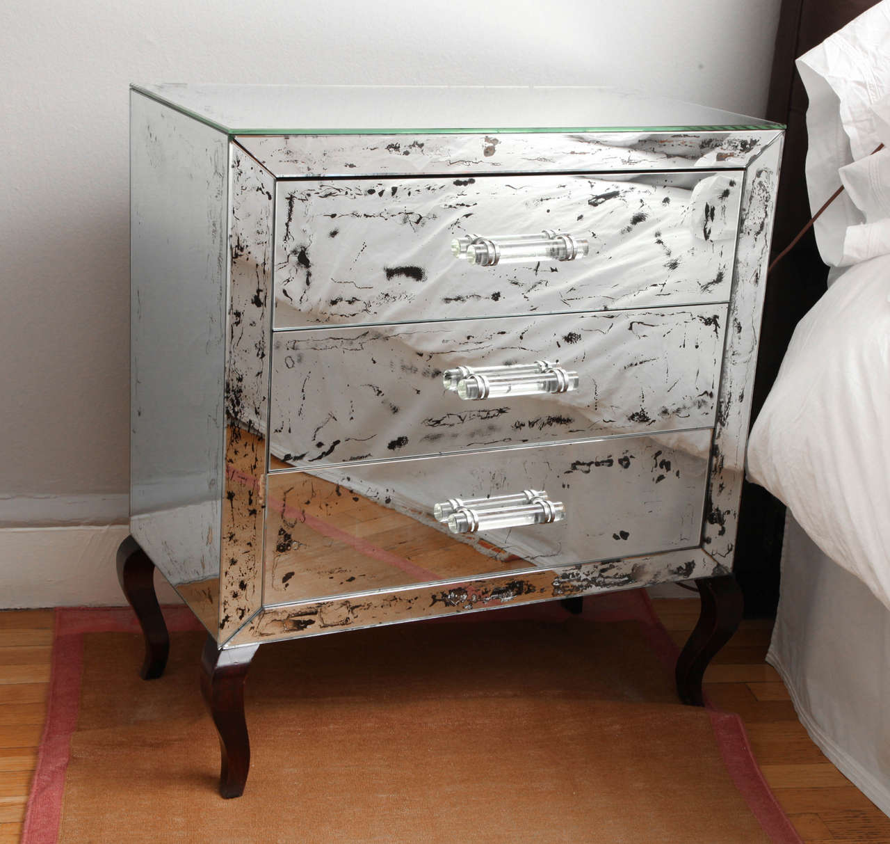 Antique-mirrored three-drawer chest with Lucite handles, glass top and wood Cabriole legs, c. 1940s. Purchased from Venfield, New York City.