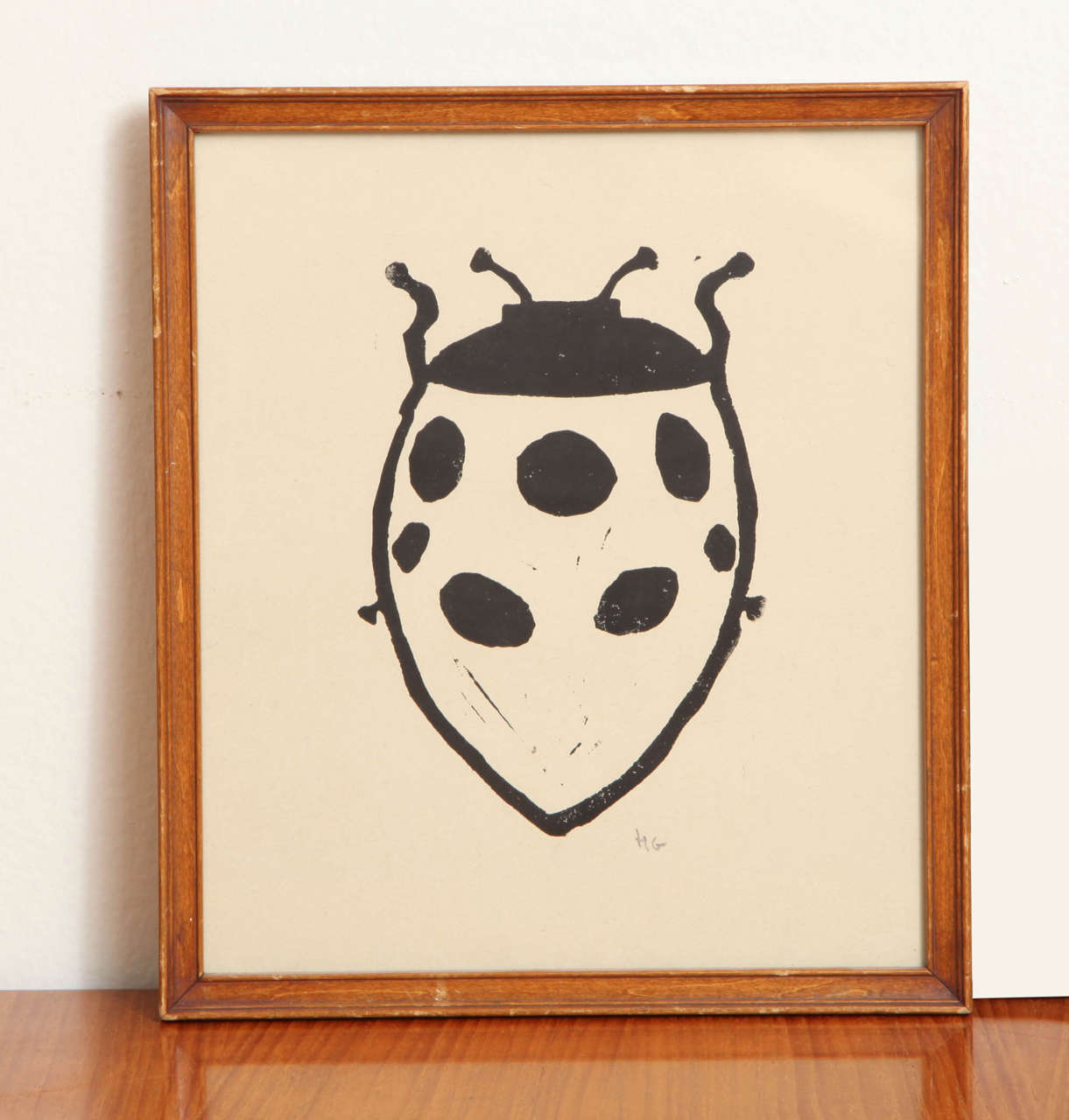 Small ladybug print by Hugo Guinness in wood frame. India ink on paper.