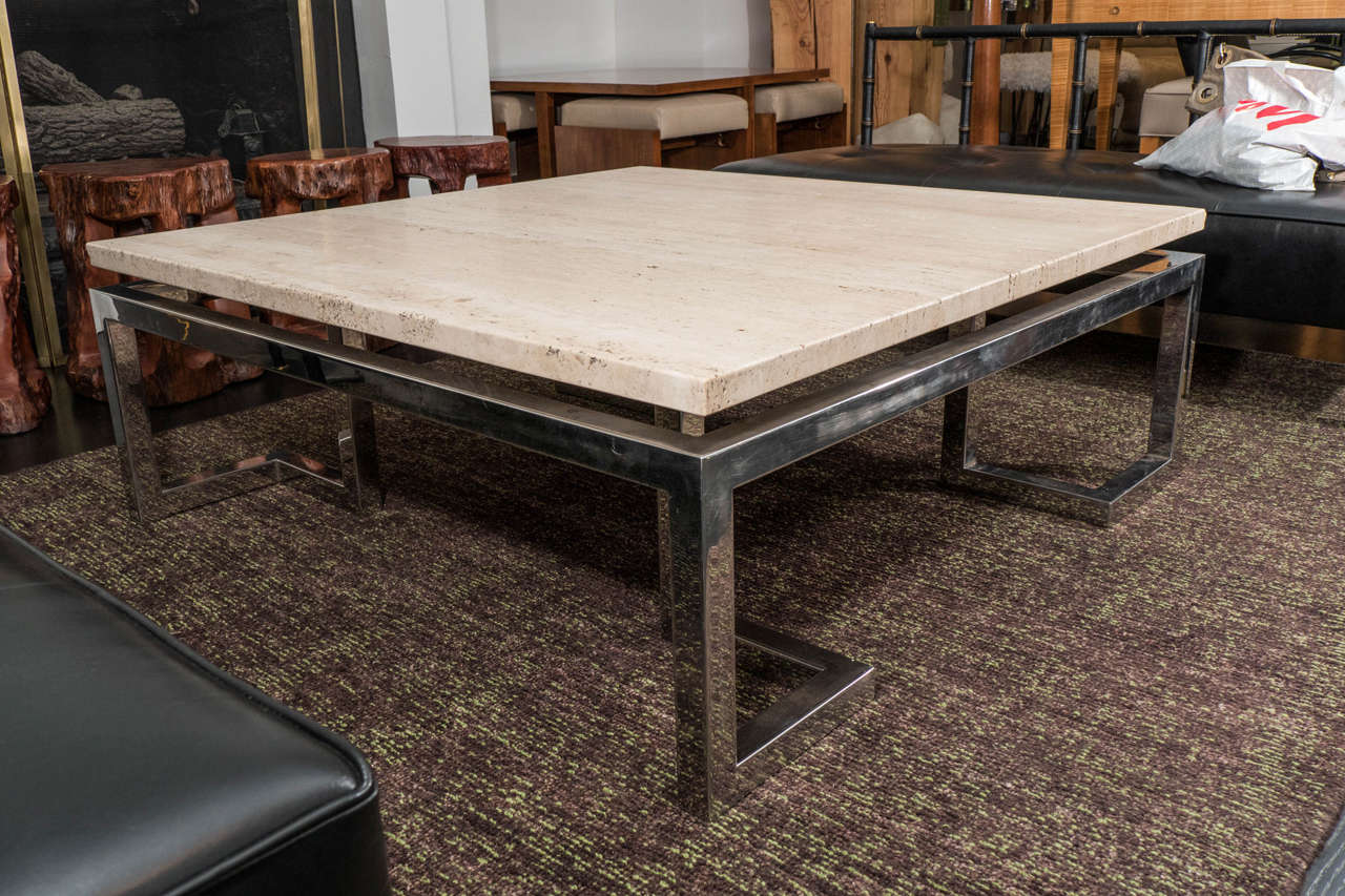Chrome finished, Greek key based table with a floating travertine top. Large scale with very elegant proportions. original finish and top; open to customization.