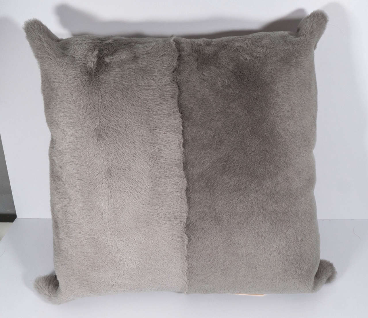 Genuine full skin sheared goatskin pillow in pale grey with leather backing.